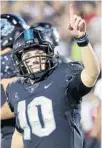  ??  ?? UCF quarterbac­k McKenzie Milton, back after missing one game, celebrates after scoring a touchdown Thursday night.