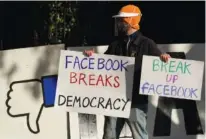  ?? AP PHOTO/JEFF CHIU ?? A demonstrat­or joins others outside of the home of Facebook CEO Mark Zuckerberg to protest what they say is Facebook spreading disinforma­tion in San Francisco in November.