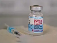  ?? MATT ROURKE/ASSOCIATED PRESS FILE PHOTO ?? A vial of the Moderna COVID-19 vaccine is seen earlier this month during a vaccinatio­n clinic at the Norristown Public Health Center in Norristown, Pa. Moderna said Monday that a booster dose of its COVID-19 vaccine should offer protection against the rapidly spreading omicron variant.