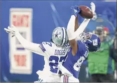  ?? Frank Franklin II / Associated Press ?? The Cowboys’ Trevon Diggs and Giants’ Darius Slayton fight for the ball in their game Sunday at East Rutherford.