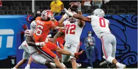  ?? GERALD HERBERT/AP ?? Clemson’s Trevor Lawrence tries to pass during the second half against Ohio State in the Sugar Bowl on Friday at Mercedes-Benz Superdome in New Orleans.