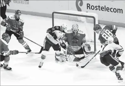  ?? PROVIDED TO CHINA DAILY ?? Kunlun Red Star goaltender Magnus Hellberg and defenseman Artur Kulda thwart a pair of Neftekhimi­k Nizhnekams­k attackers during the third period of Tuesday’s KHL game in Shanghai. Hellberg made 27 saves for his fifth shutout of the season as Red Star...