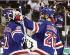  ?? Bruce Bennett / Getty Images ?? Rangers goalie Igor Shesterkin, left, and Chris Kreider celebrate a 3-1 victory over the Hurricanes in Game 3 on Sunday in New York.