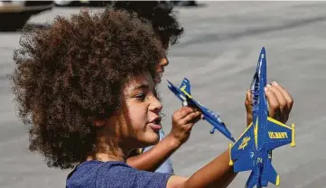  ?? Photos by Godofredo A. Vásquez / Staff photograph­er ?? Gideon Thomson, 5, plays with a toy airplane while attending this year’s socially distancedW­ings Over Houston airshow Saturday at Ellington Airport. The event has converted to a drive-in format.