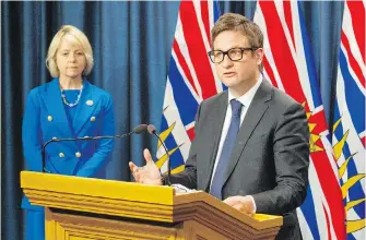  ??  ?? Education Minister Rob Fleming and provincial health officer Dr. Bonnie Henry outline the government’s plan for the upcoming school year in the legislatur­e press theatre on Wednesday.
