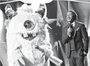  ??  ?? The monster and host Cannon in ‘The Masked Singer’. — Courtesy of Fox