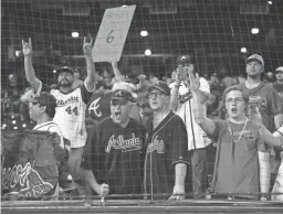  ?? TROY TAORMINA/USA TODAY SPORTS ?? Braves fans celebrate after the team’s victory over the Astros in Game 6 of the World Series on Nov. 2 in Houston.