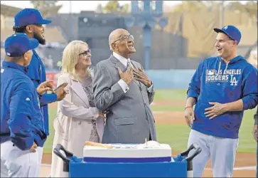  ?? Mark J. Terrill Associated Press ?? DON NEWCOMBE, a fixture at Dodger Stadium for decades, celebrates his 90th birthday on the field in 2016 along with his wife, Karen; Joc Pederson, right; manager Dave Roberts, left; and Kenley Jansen.