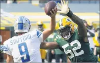  ?? MORRY GASH — THE ASSOCIATED PRESS ?? Detroit Lions’ Matthew Stafford throws an intercepti­on while being pressured by the Green Bay Packers’ Rashan Gary, right, during Sunday’s loss. Detroit has lost 11 straight games overall.