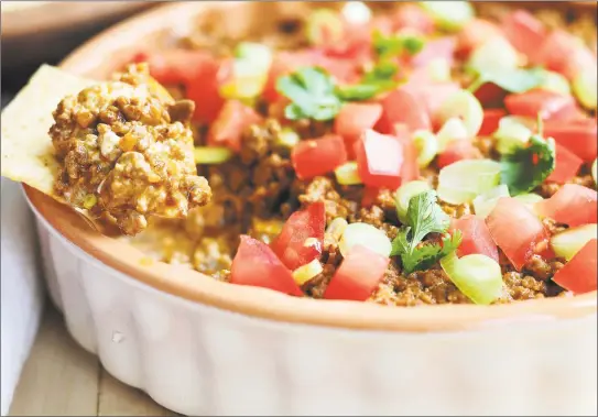  ?? McCormick / Contribute­d Photo ?? Easy cheesy taco dip can be paired with tortilla chips or fresh veggies.