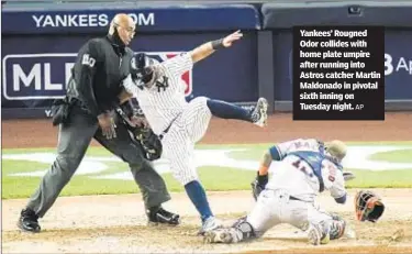  ?? AP ?? Yankees’ Rougned Odor collides with home plate umpire after running into Astros catcher Martin Maldonado in pivotal sixth inning on Tuesday night.