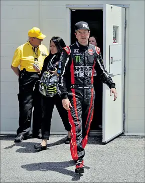  ?? ASSOCIATED PRESS ?? MICHAEL CONROY Kurt Busch walks out of the track medical center after his crash. His car didn’t fare as well and will need reconstruc­tion this week.