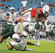  ?? AL DIAZ / MIAMI HERALD ?? University of Miami quarterbac­k D’Eriq King leaps for a second-quarter touchdowna­gainstUAB on Sept. 10. The No. 17Hurrican­es face amuch sterner test today in No. 18 Louisville.