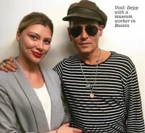  ??  ?? Visit: Depp with a museum worker in Russia