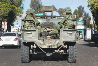  ?? Janet Jarman ?? Mexican troops patrol the city of Salamanca in Guanajuato state. President Andrés Manuel López Obrador ordered troops to the area in late December to combat organized crime.
