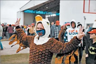  ?? CHRIS SWEDA PHOTOS/CHICAGO TRIBUNE ?? To show her patriotism, Gina Lechner, 37, of Oregon, Wisconsin, dressed in a bald eagle costume and Trump mask at a campaign rally for President Donald Trump on Saturday at Janesville, Wisconsin.