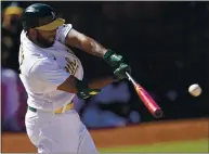  ??  ?? The Athletics’ Elvis Andrus hits a double to drive in a run against the Tampa Bay Rays during the eighth inning Saturday.