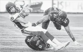  ?? SCOTT GARDNER THE HAMILTON SPECTATOR ?? Ottawa Redblacks wide receiver Greg Ellington is downed by Hamilton Tiger-Cats Larry Dean (11) and Simoni Lawrence during Canadian Football League action at Tim Hortons Field on Saturday afternoon.