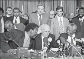  ?? LYNNE SLADKY/AP PHOTO ?? This April 19, 1994, file photo shows in the front row; Inkatha Freedom Party (IFP) Chief Mangosuthu Buthelezi, left, President F.W. de Klerk, middle, and African National Congress (ANC) President Nelson Mandela, right, exchanging words at a news conference, while in the back row at center South African Foreign Minister “Pik” Botha looks over them, in Pretoria, South Africa.