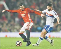 ??  ?? File photo shows Manchester United’s Henrikh Mkhitaryan (left) in action with Wigan Athletic’s Sam Morsy during the FA Cup fourth round at Old Trafford. — Reuters photo