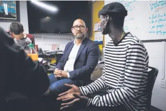  ??  ?? Newly elected District Eight Supervisor Rafael Mandelman (left) talks with client Richard Reavson, 23, during a tour of Larkin Street Youth Services.