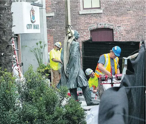  ??  ?? A harness is strapped to the statue of Canada’s first prime minister, Sir John A. Macdonald, on Aug. 11, 2018, after Victoria city council voted to remove it from outside city hall as an act of reconcilia­tion with First Nations.