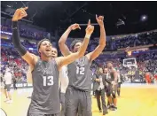  ?? MARK HUMPHREY/AP ?? Nevada’s Hallice Cooke, left, and Elijah Foster, right, celebrate after the Wolf Pack’s Sunday upset of Cincinnati in Nashville, Tenn., in the NCAA Tournament.