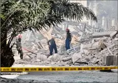  ?? Adalberto Roque/AFP / TNS ?? Rescuers look for people after an explosion in the Saratoga Hotel in Havana,. A powerful explosion Friday destroyed part of the hotel under repair in central Havana.