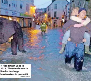  ?? Wayne Perry ?? Flooding in Looe in 2013. The town is now in line for two huge breakwater­s to protect it