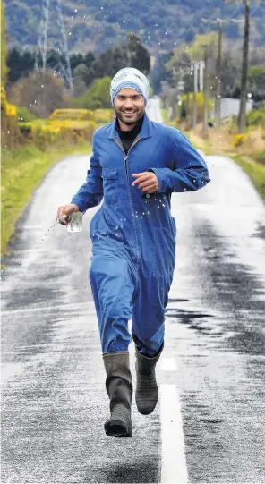  ?? PHOTO: STEPHEN JAQUIERY ?? Booting it . . . Woodside dairy farmer Harrie Chander is training to run the Queenstown Marathon in his work overalls and gumboots.