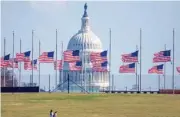  ?? GETTY IMAGES ?? With the dome of the U.S. Capitol in the background , flags fly at half staff in mourning for the victims of the mass shootings at Marjory Stoneman Douglas High School in Parkland, Florida.