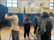  ?? NICHOLAS BUONANNO — NBUONANNO@TROYRECORD.COM ?? San Francisco 49ers running back Matt Breida signs autographs for students in the Alternativ­e Learning Program at School 12in Troy after he spoke to the students there about his success story and his brother’s bad decisions in life as well.