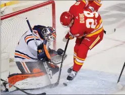  ?? Canadian Press photo ?? Edmonton Oilers goalie Mike Smith makes a save on Calgary Flames' Dillon Dube during the first period of their NHL hockey game in Calgary, Friday.