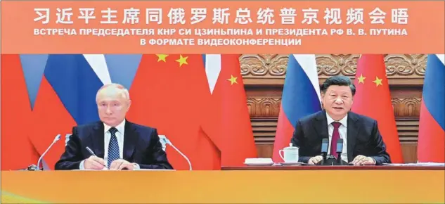  ?? YUE YUEWEI / XINHUA ?? President Xi Jinping in Beijing holds a meeting with Russian President Vladimir Putin via video link on Dec 30.