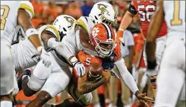  ?? JOHN BAZEMORE/AP FILE ?? Clemson QB D.J. Uiagalelei (5) fumbles against Georgia Tech during last year’s game in Clemson, S.C. The schools have met 87 times in a series that began in 1898, and their geographic proximity could keep them as permanent opponents.