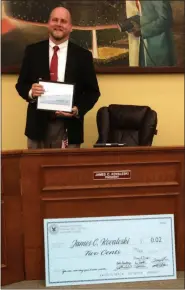  ?? EVAN BRANDT — MEDIANEWS GROUP ?? Known for offering “my two cents,” when giving his opinion, outgoing Phoenixvil­le Borough Council President James Kovaleski received a ‘big check’ for two cents at the Dec. 10 council meeting, which was his last.