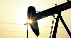  ?? THE ASSOCIATED PRESS FILES ?? An oil pump works at sunset in the desert oil fields of Sakhir, Bahrain. OPEC member states and other major oil producers are planning to meet next month to discuss a freeze in oil output levels, Qatar’s top energy official said Wednesday.