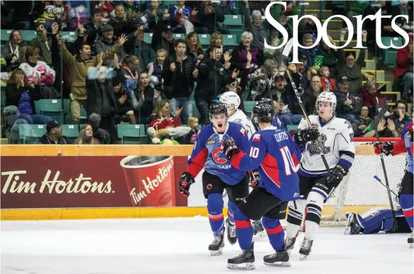  ?? CITIZEN PHOTO BY JAMES DOYLE ?? Josh Maser celebrates on the ice and Prince George Cougars fans celebrate in the seats after Maser scored the Teddy Bear Toss goal on Sunday afternoon at CN Centre. Maser finished the game with a hat trick, his first in the Western Hockey League. The...