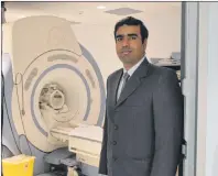  ?? NIKKI SULLIVAN / CAPE BRETON POST ?? Dr. Syed Zafar Ali, chief radiologis­t at the Cape Breton Regional Hospital, stands next to the current MRI machine. It was announced on Tuesday the hospital has been given the go ahead to buy a new MRI machine.