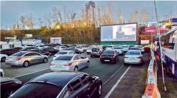  ?? AFP ?? An outdoor screen shows a movie at a drive-through cinema in Seoul.
—