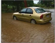  ?? (AP/Carlos Giusti) ?? A car sits in floodwater­s Saturday caused by Tropical Storm Laura in Salinas, Puerto Rico.