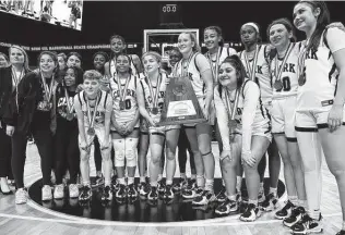  ?? Photos by Kin Man Hui / Staff photograph­er ?? With medals draped around their necks, players and coaches for the Clark Cougars pose with the UIL state semifinal trophy after falling to DeSoto on Friday night at the Alamodome.