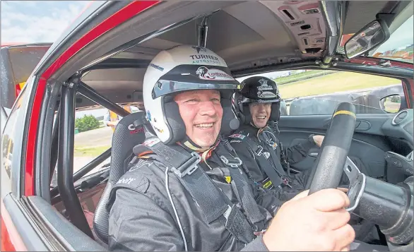  ?? Picture: SNS ?? RIDE OF HIS LIFE: Ally McCoist strapped into the driver’s seat with helmet in place for a few laps round the track at Knockhill before talking to journalist­s.