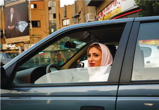  ??  ?? IRAN’S JUDICIARY has said women must wear the mandatory head covering even in cars. Opponents argue the car is a private space.