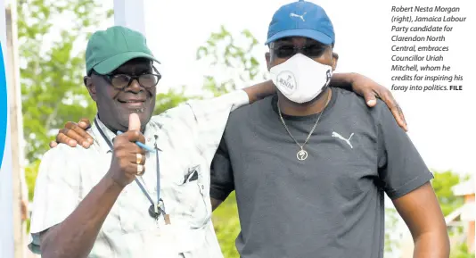  ?? FILE ?? Robert Nesta Morgan (right), Jamaica Labour Party candidate for Clarendon North Central, embraces Councillor Uriah Mitchell, whom he credits for inspiring his foray into politics.