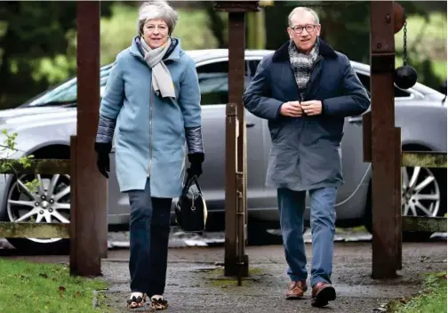  ?? Daniel Leal-olivas/agence France-presse ?? Britain’s Prime Minister Theresa May (left) arrives to attend a church service with her husband Philip.