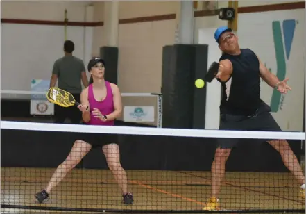  ?? BARRY TAGLIEBER — FOR MEDIANEWS GROUP ?? Brady Kramer returns the ball as partner Kim Bohrer backs up the play during the first Pickleball Tournament sponsored by the Phoenixvil­le YMCA.