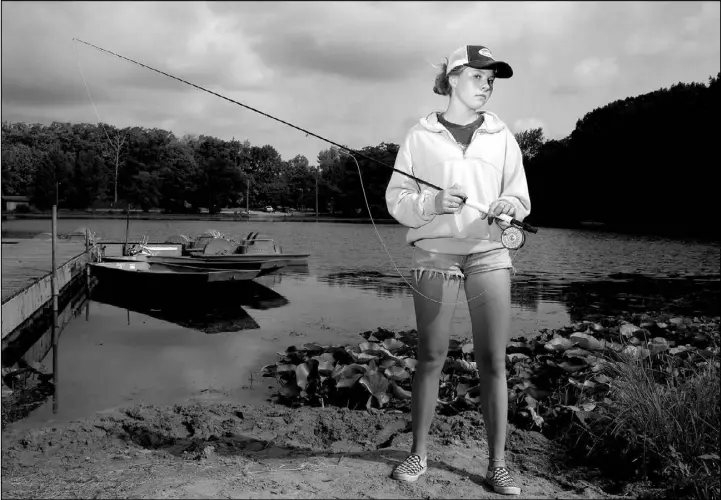  ?? PHOTOS BY JOSHUA LOTT / THE NEW YORK TIMES ?? Maxine McCormick, 14, is seen before participat­ing in the national casting championsh­ips at Rogers-Lakewood Park in Valparaiso, Ind., in July. In the five years since she began f ly casting, she has become the sport’s youngest champion. “I never knew I would become this good at anything,” she said.