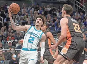  ?? PHELAN M. EBENHACK/AP ?? Hornets guard Lamelo Ball drives to the basket against Magic forward Franz Wagner on Nov. 24 in Orlando.