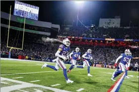  ?? ADRIAN KRAUS — THE ASSOCIATED PRESS ?? Buffalo Bills safety Micah Hyde, center, celebrates after catching an intercepti­on during the first half of an NFL wild-card playoff football game against the New England Patriots, Saturday, Jan. 15, 2022, in Orchard Park, N.Y.